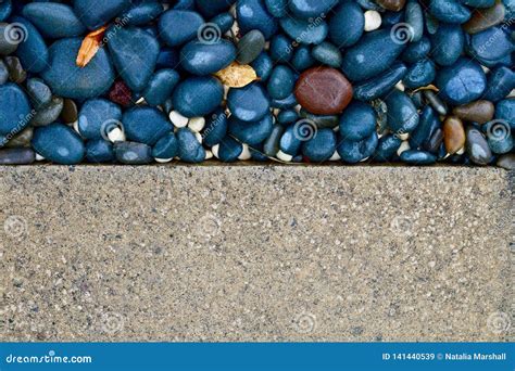 Contrast Textures of a Paved Driveway and Pebbled Sidewalk. Background ...