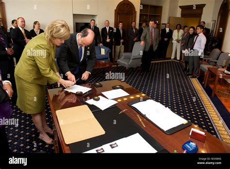 US Marshals Service Director Stacia Hylton and Robert W. Mathieson sign paperwork after swearing ...