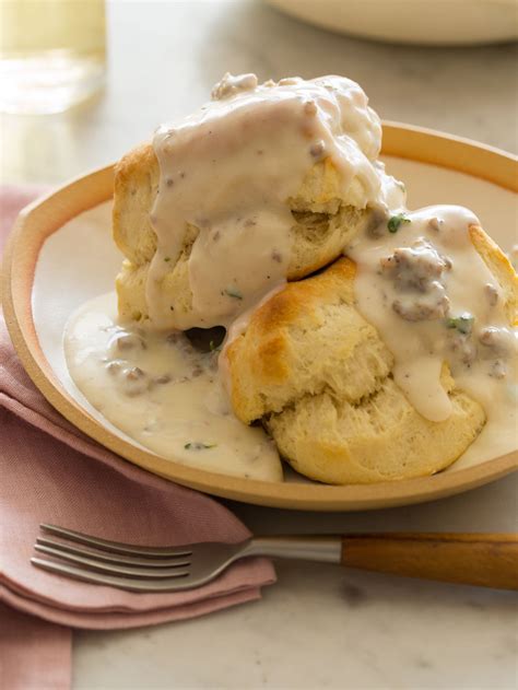 two biscuits covered in gravy on a plate