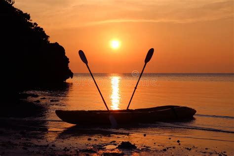 Kayaking on the Beach with Red Sky Sunset. Stock Image - Image of summer, background: 77888693