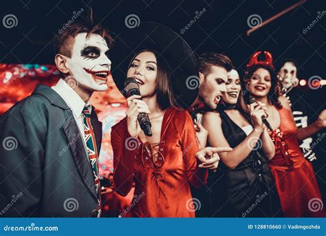 Young People in Halloween Costumes Singing Karaoke Stock Photo - Image of party, expressing ...