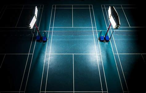 Indoor badminton court with bright white lights