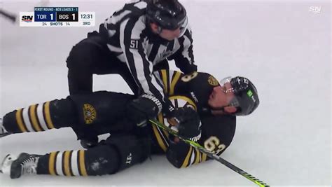 Brad Marchand Hit by Referee and Knocked Down During Scrum