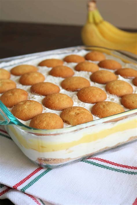 a casserole dish filled with baked goods on a table next to a banana