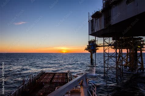 Oil rig in sunset Stock Photo | Adobe Stock