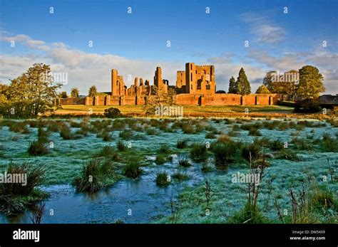 The ruins of Kenilworth Castle in Warwickshire on a frosty winter morning seen across the field ...