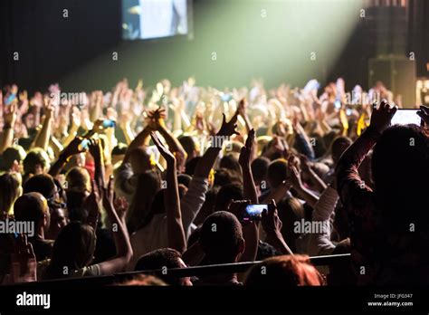 Crowd at concert and blurred stage lights Stock Photo - Alamy