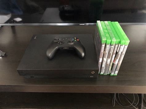 BARELY USED! Xbox one x with controller and games | in Bridgend | Gumtree