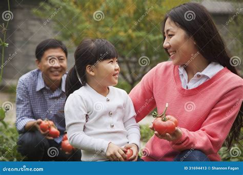 Happy family in garden stock image. Image of clothing - 31694413