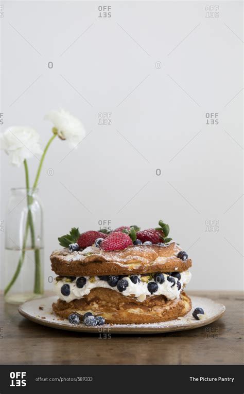 A layered cream sponge and fruit cake stock photo - OFFSET