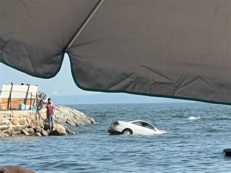 Car drives into Long Island Sound at Norwalk Bayley Beach in Rowayton