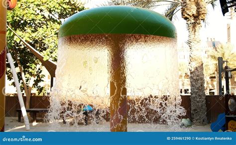 Playground by the Pool, with Fountains. Waterfall from a Fountain Cascading Stock Photo - Image ...