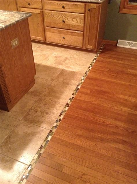 Transition between hardwood and tile floor... We should do this. Sooooo ...