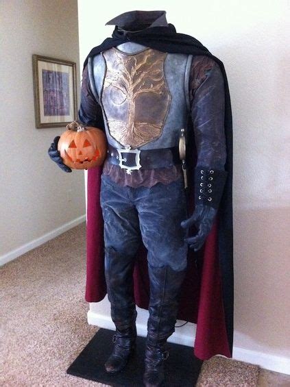 a man dressed in costume and holding a pumpkin