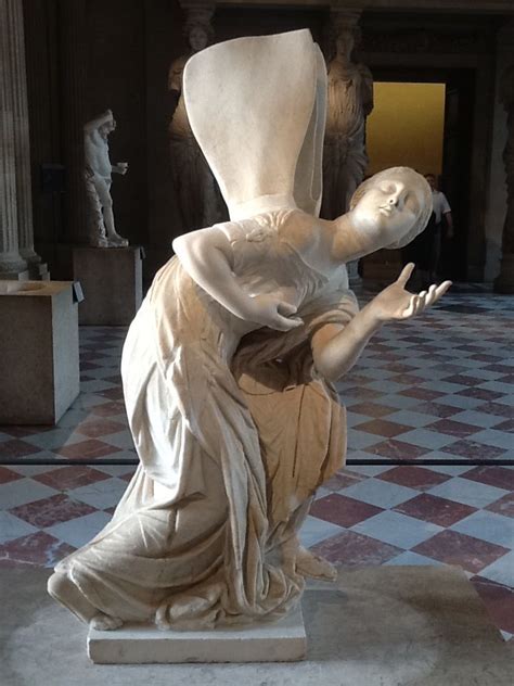 a statue in the middle of a room with checkered flooring and marble walls