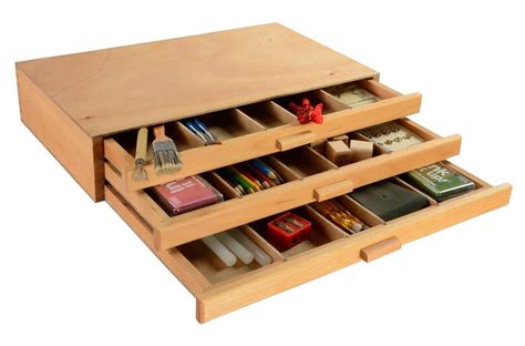 two wooden drawers filled with different types of items