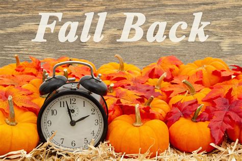 Fall Back time change message with a retro alarm clock with pumpkins and fall leaves | MercerMe