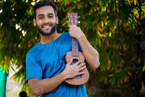 boy with ukulele a musical instrument Handsome Indian musician image ...