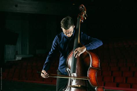 "Musician Playing Double Bass On Stage" by Stocksy Contributor "Branko Starcevic" - Stocksy