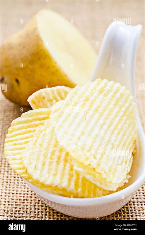 chips and peeled potato on a sack background Stock Photo - Alamy