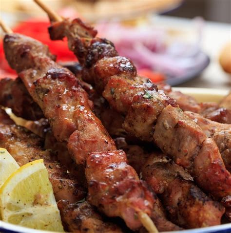 Premium Photo | Grilled meat skewers on a table closeup view