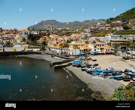 Colourful boats lie on the beach of Camara de Lobos on the Portuguese island of Madeira Stock ...