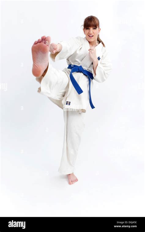 Young woman in a karate suit practicing kicks Stock Photo: 61864026 - Alamy