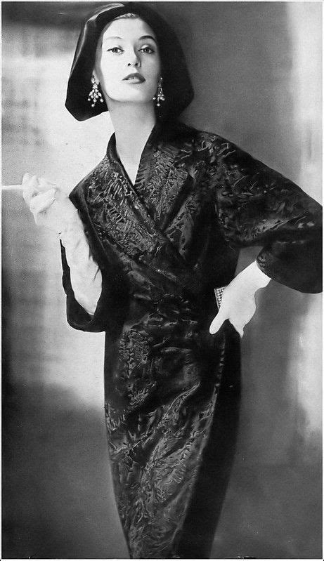 Barbara Mullen in black-dyed Russian broadtail lamb wrap coat by Ben Kahn, satin coif hat by ...