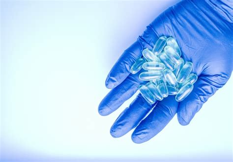 Premium Vector | Realistic medical organ concept with a hand in a blue rubber glove holding a ...