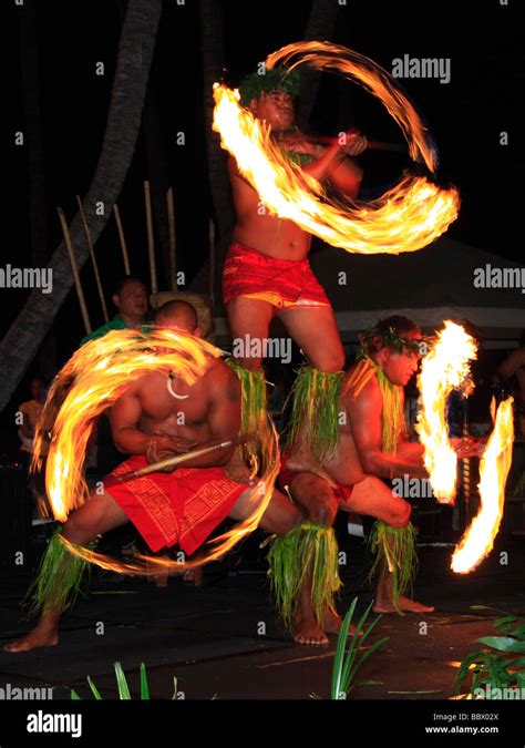 Traditional Hawaiian fire dance performed by three mail dancers Stock ...