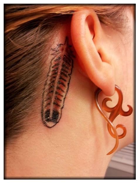 Red tail hawk feather tattoo's behind right ear. Surprisingly not a ...