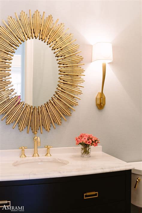 a bathroom sink with a mirror above it and a vase on the counter next to it