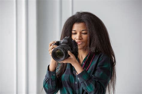 An African-American Photographer Girl with a Camera. Photo Shoot in the ...