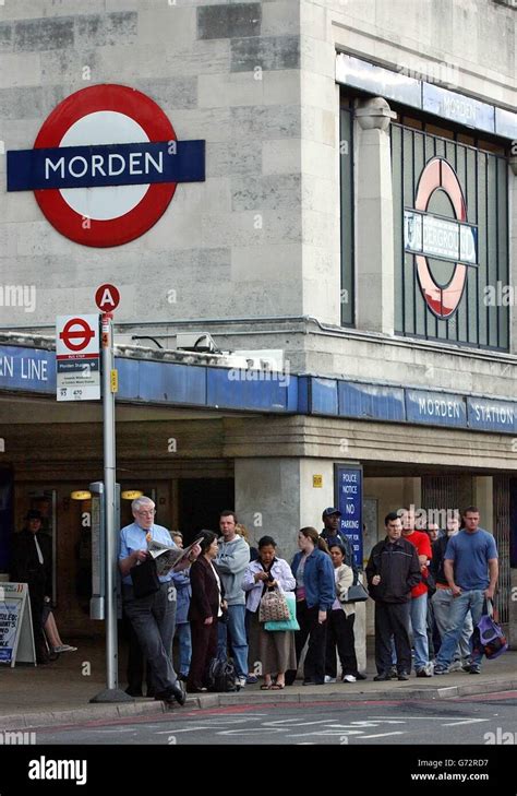 Commuters queue for a bus outside Morden station, as a 24 hour strike by thousands of workers on ...