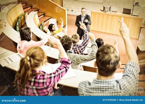 Students Raising Hands with Teacher in Lecture Hall Stock Image - Image ...