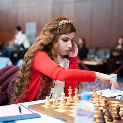 a woman playing chess in an office setting