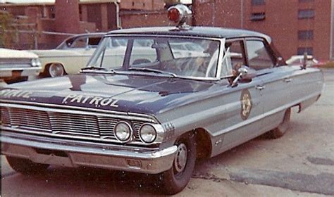 an old police car is parked on the street