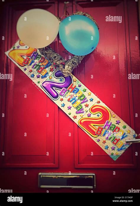 Happy 2nd birthday banner on a red front door Stock Photo - Alamy