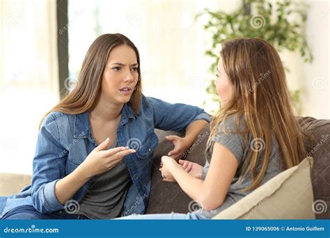 Serious Women Talking on a Couch at Home Stock Photo - Image of annoyed, guest: 139065006