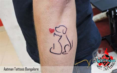 a tattoo on the arm of a man with a dog and heart