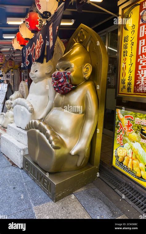 Billiken character statue outside a restaurant in Shinsekai, Osaka ...