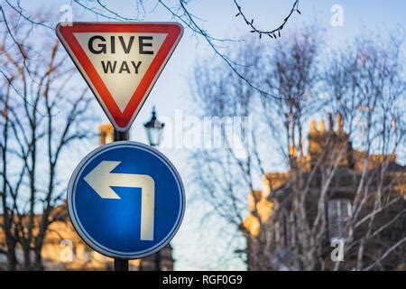 Stop and give way road sign on white background Stock Photo - Alamy