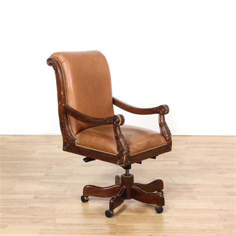 This traditional office chair is featured in a solid wood with a glossy ...