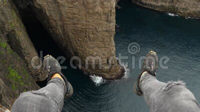 View of Sorvagsvatn Lake Above the Ocean and Legs Man Sitting Edge ...