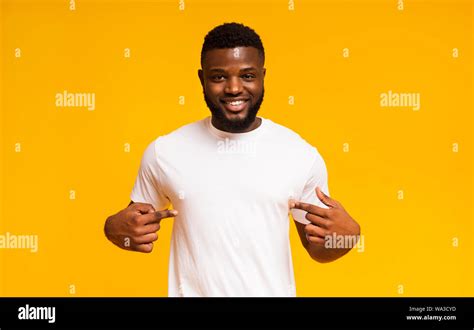 Self-assured and charismatic black man promoting himself, pointing at body Stock Photo - Alamy