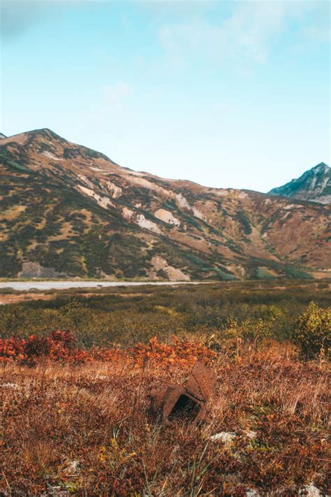 Mountainous terrain near grassy valley on clear day · Free Stock Photo