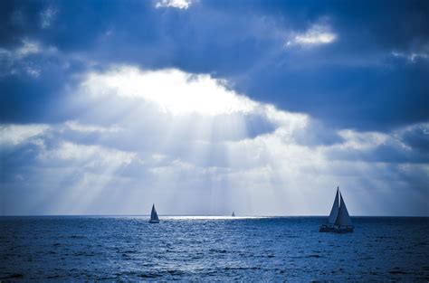 Two sailboats on body of water under crepuscular rays HD wallpaper ...