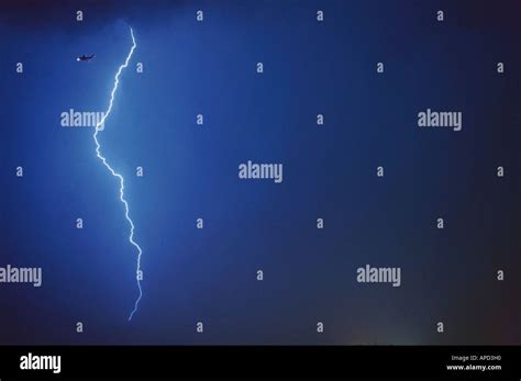 Lightning bolt Airplane flying in bad weather Stock Photo - Alamy