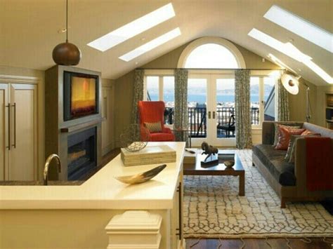 Attic living room with fireplace and skylights | Above garage apartment, Room above garage ...