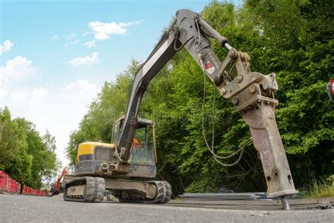 Excavator with Hydraulic Jack Hammer Breaking Asphalt in Preparation ...